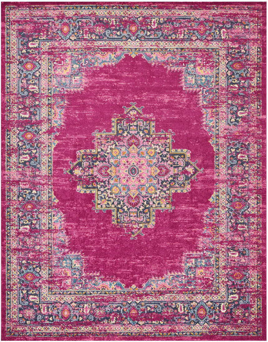 Close-up of Nourison Passion Fuchsia rug. Bohemian style with a central medallion and ornate floral border. Fuchsia, pink, blue, and yellow tones.