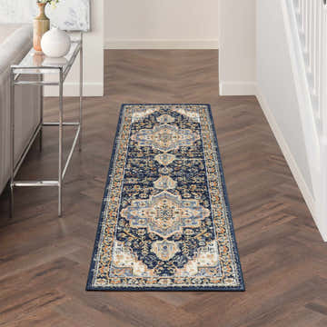 Hallway with Nourison Essentials Persian Navy Vintage Area Rug runner on dark wood floor.
