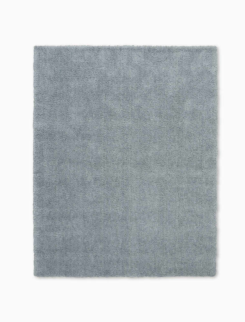 Close-up of the Calvin Klein Chicago Shag rug. Soft, grey, and modern, this rug has a plush, inviting texture.