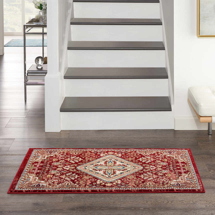 Entryway with Nourison Karisma Brick Ivory rug, dark wood floors, white stairs, and modern decor.