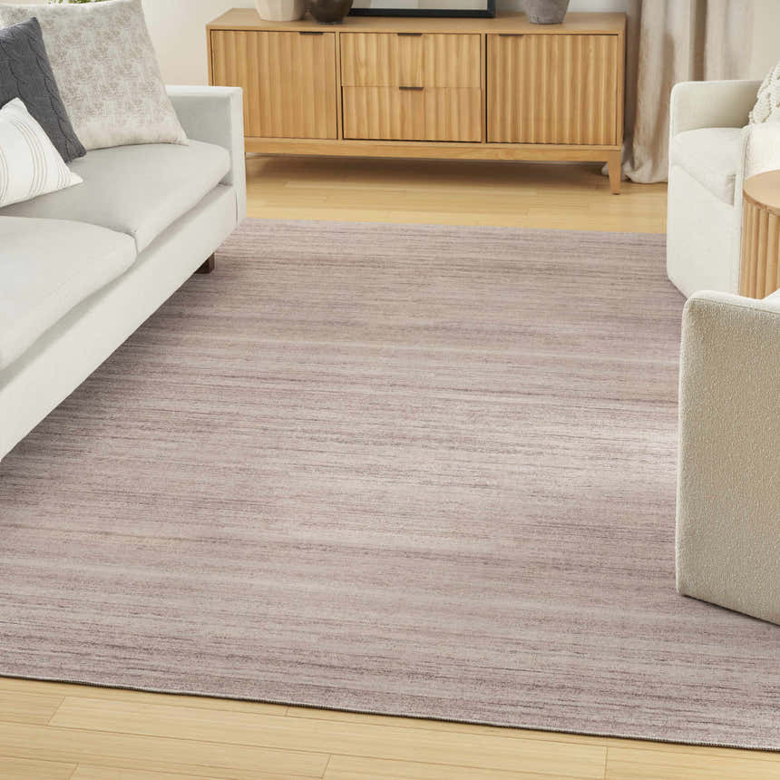 Living room with white sofa, wood cabinet, and Nourison Essentials Ivory Mocha Area Rug.