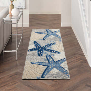 Hallway with Nourison Aloha Blue Grey Coastal rug. Features blue starfish, shell pattern, and wood floors.