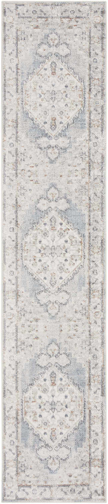 Close-up of Nourison Astra Light Blue Vintage Rug. Machine-made runner with distressed light blue, beige, and brown vintage pattern.