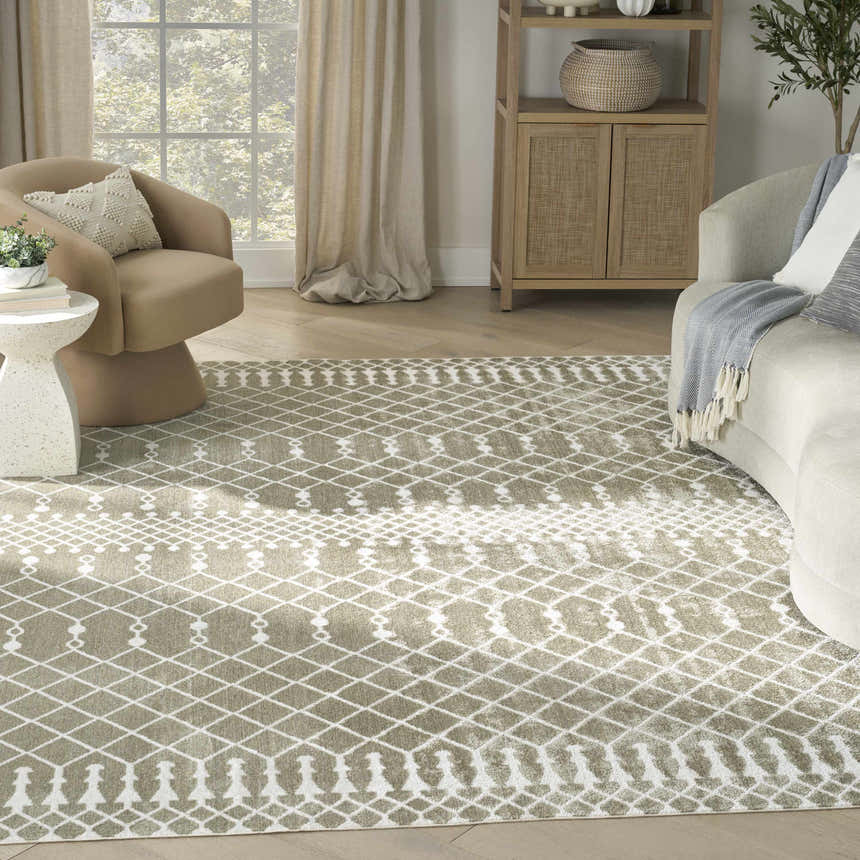 Living room scene with a Nourison Astra Sage Bohemian Rug, beige chairs, and light wood accents.