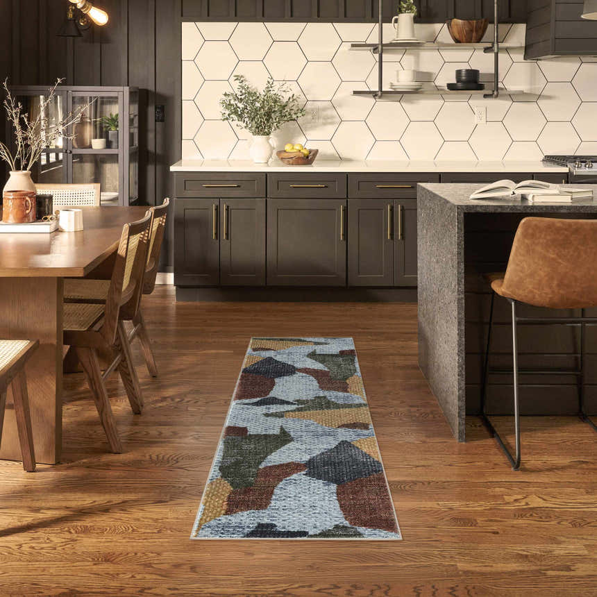 Modern kitchen and dining area with Nourison Nordic Blue Multicolor rug runner on hardwood floors.