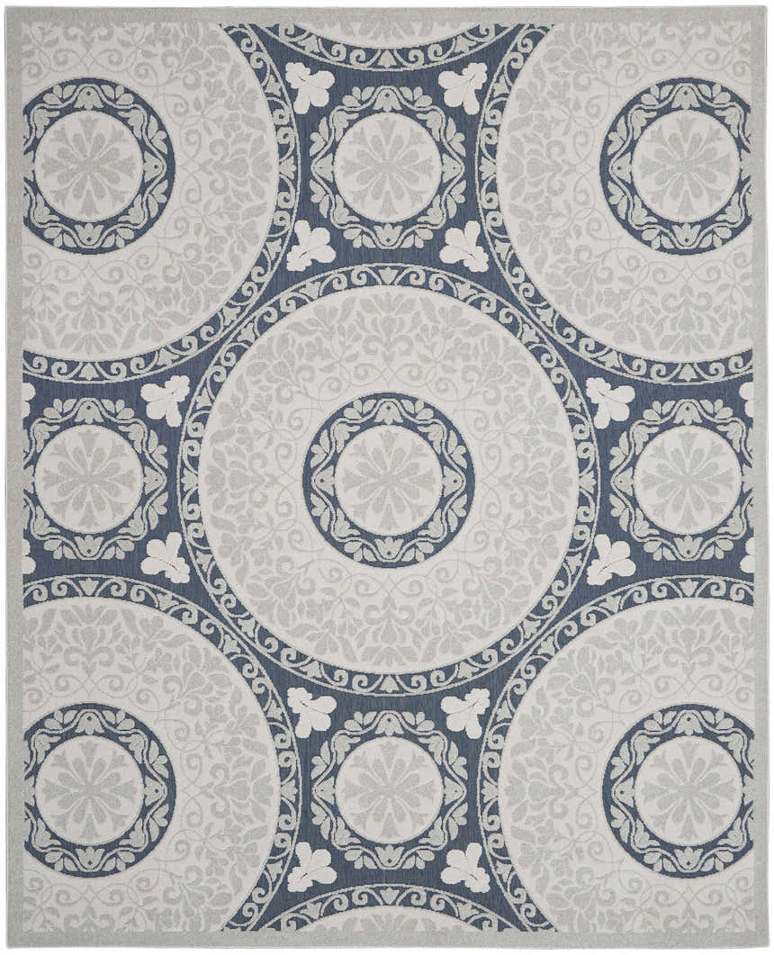 Close-up of the Nourison Key Largo Blue Contemporary Area Rug, featuring a circular pattern in light blue and gray.
