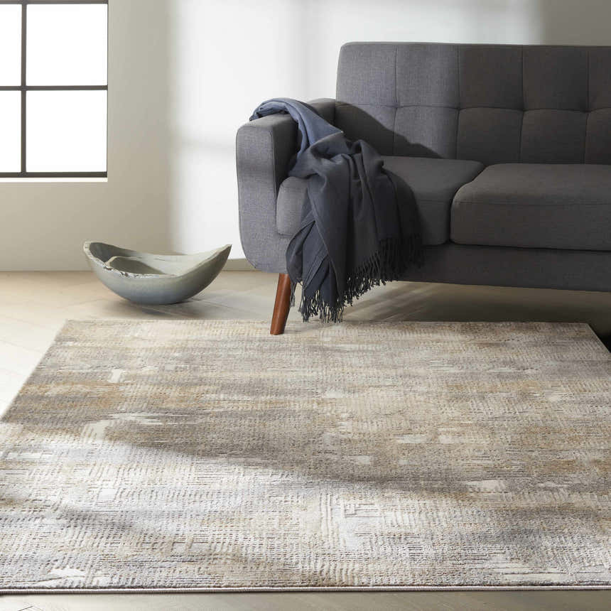 Living room scene with gray sofa and Calvin Klein CK950 Rush Grey Beige modern area rug.
