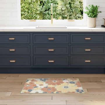 Kitchen scene with navy cabinets and Nourison Aloha Rose modern rug with floral pattern.