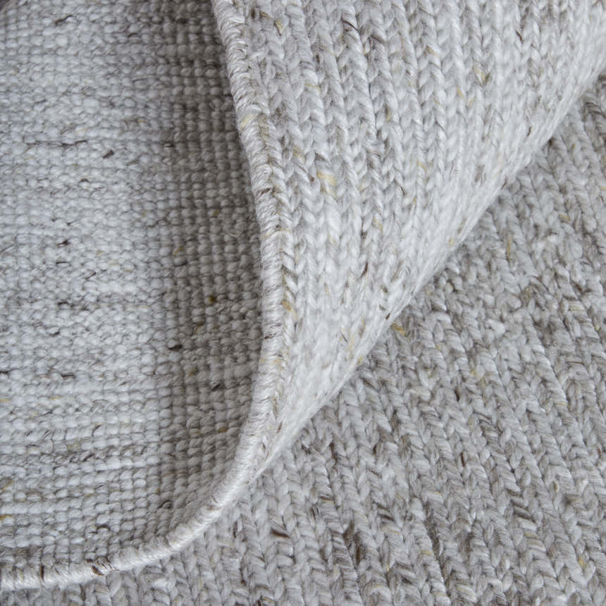 Close-up of the hand-knotted Feizy Finley Silver Area Rug showing texture and silver gray color. Fold