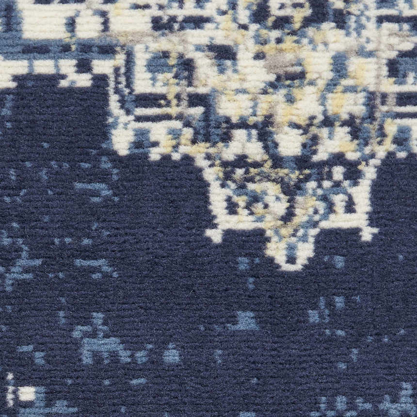 Close-up of the Nourison Grafix Navy Blue Vintage Area Rug showing texture and pattern details.