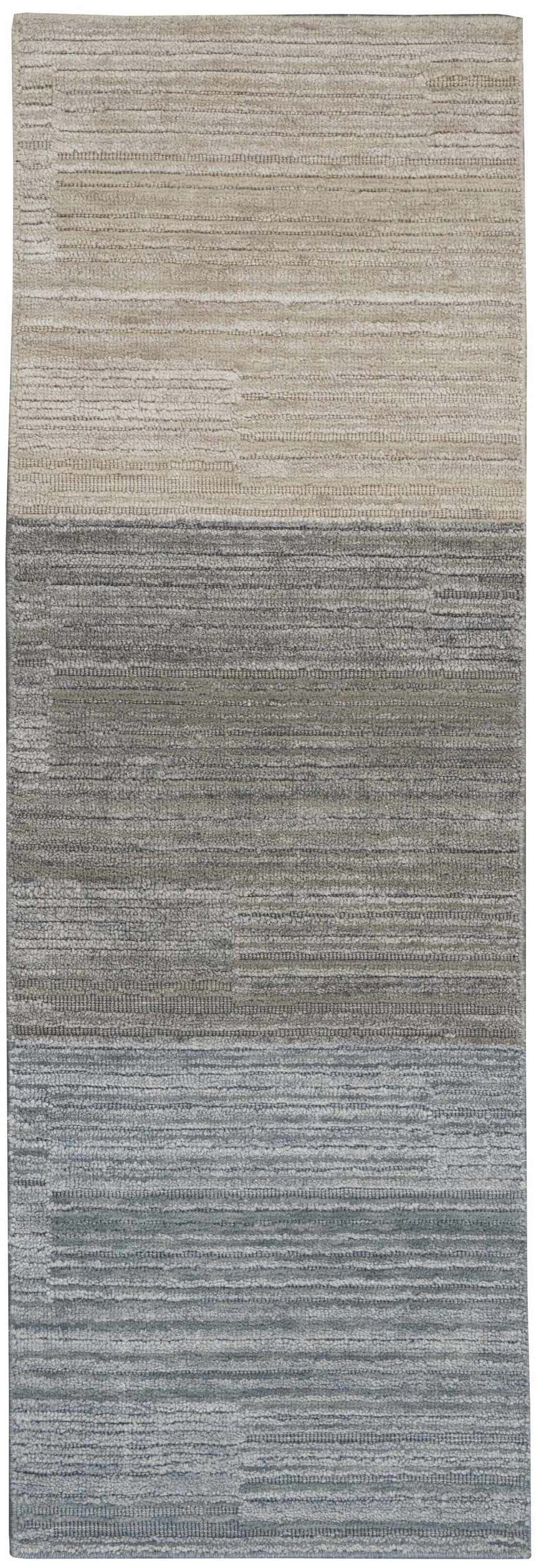 Close-up of Calvin Klein Abyss Sand rug. Contemporary design in light blue, sandstone, and silver gray with a subtle horizontal pattern.