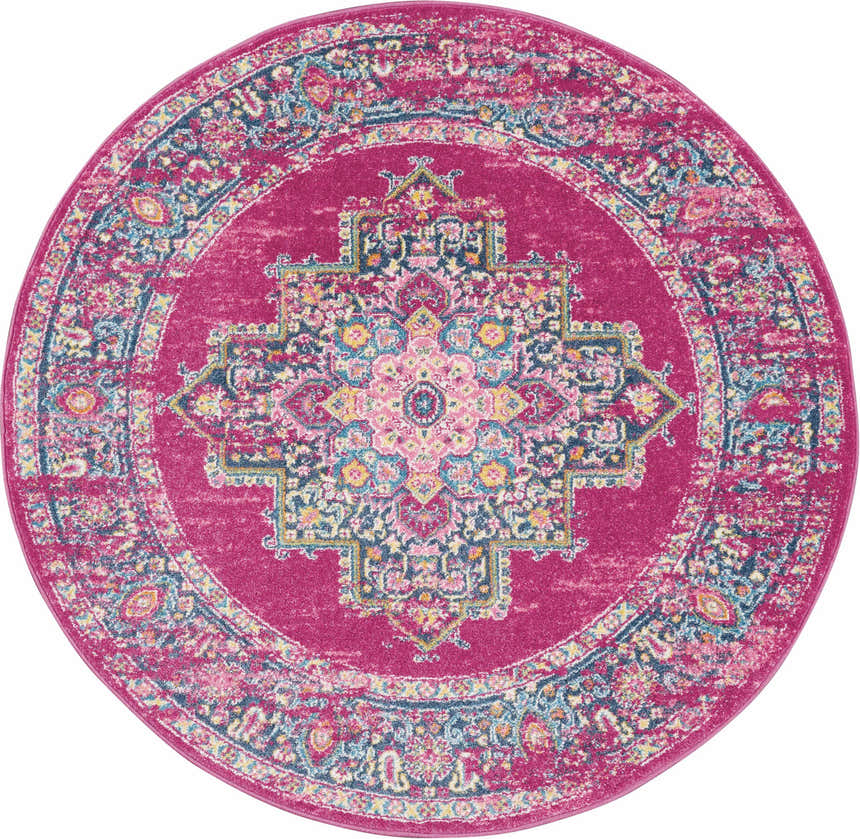 Close-up of a round Nourison Passion Fuchsia rug. Features a bohemian floral medallion design in fuchsia, blue, and yellow.