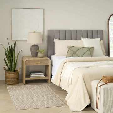 Bedroom scene with Nourison Charm Beige Ivory Rug, neutral tones, wood nightstand, and woven accents.