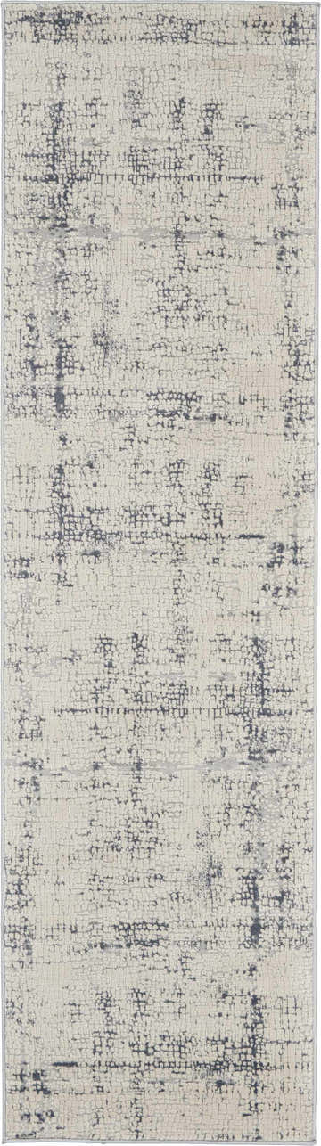 Close-up of Nourison Rustic Textures Ivory/Blue rug. Modern design with distressed pattern and subtle blue accents.