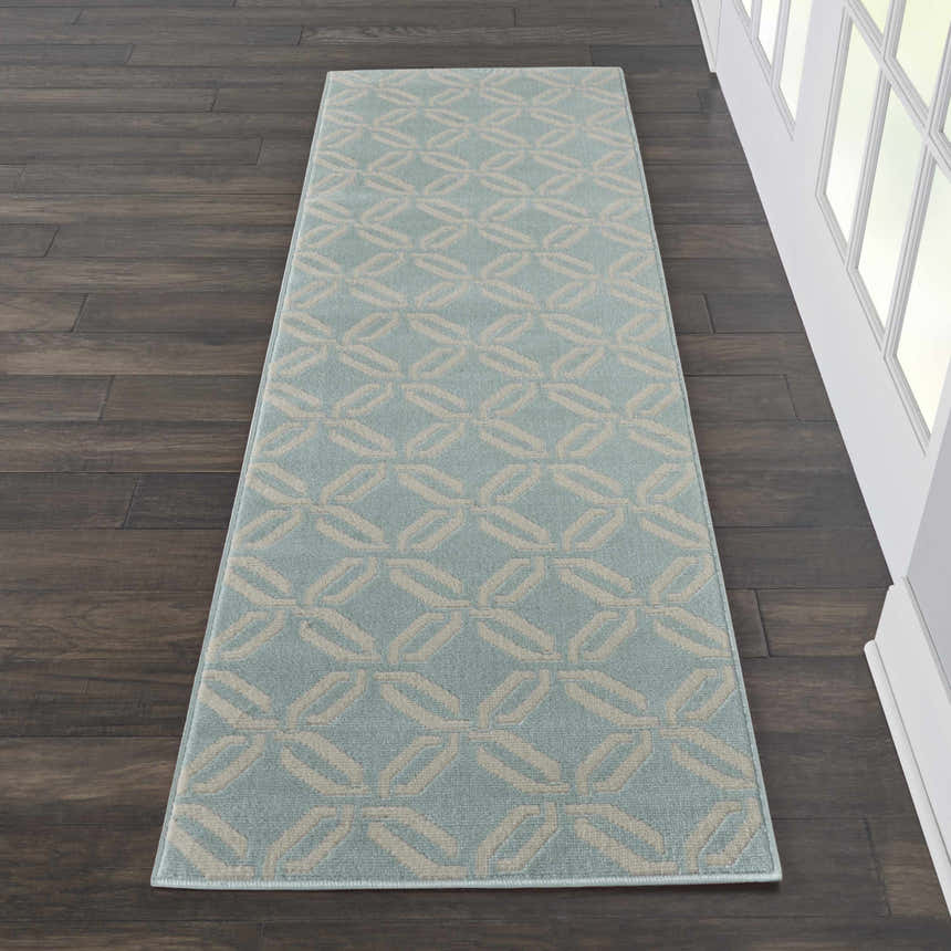 Hallway scene with Nourison Jubilant Green runner rug. Coastal style rug has a geometric pattern in green and beige.