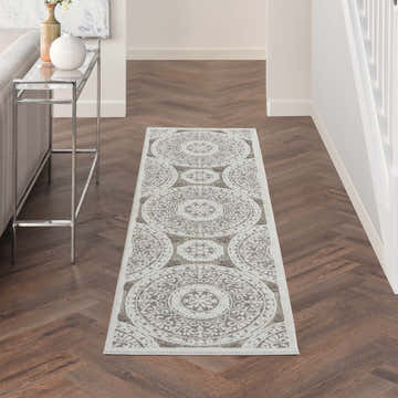 Hallway with Nourison Key Largo Taupe Contemporary Area Rug runner, wood floors, console table, and neutral decor.