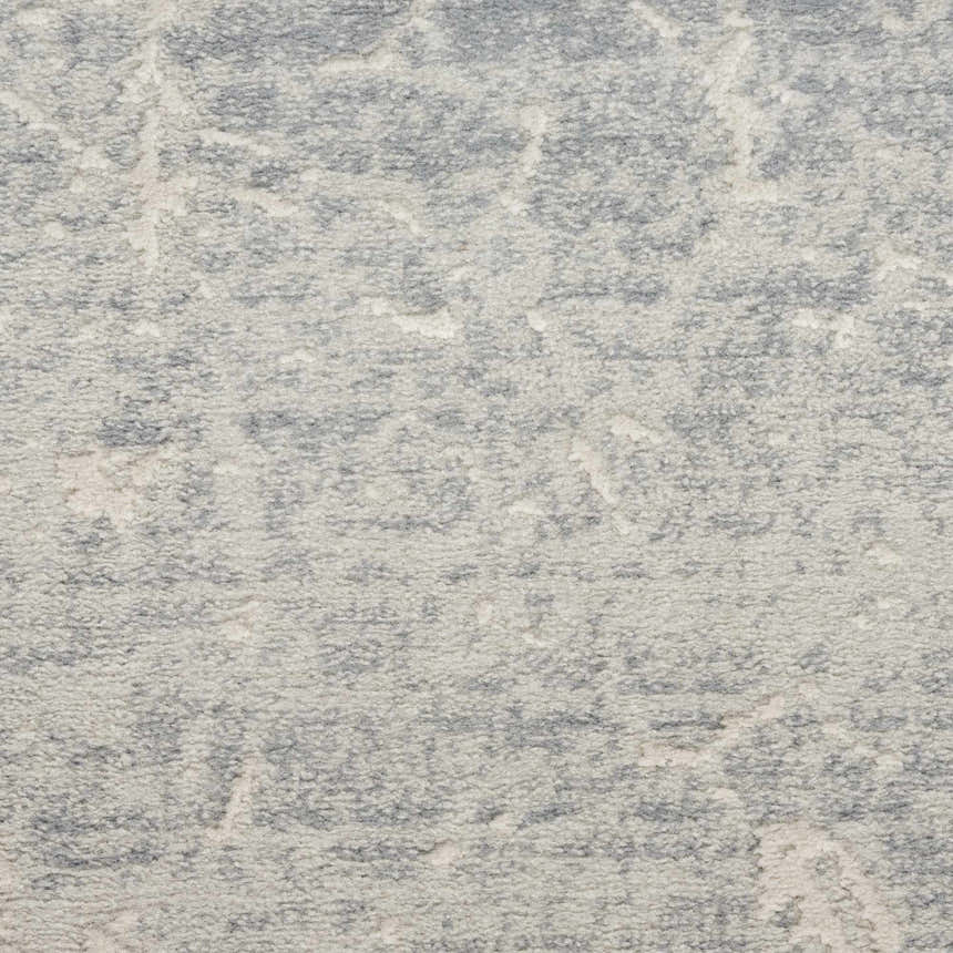 Close-up of the high pile Nourison Exhale Ivory Grey rug, showing its subtle pattern and soft texture.