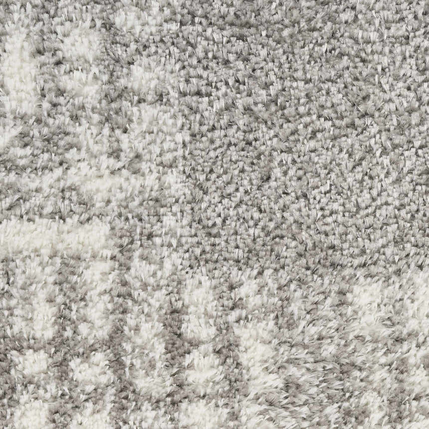 Close-up of the plush texture and subtle gray and white pattern of the Nourison Pacific Shag Grey Area Rug.