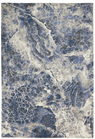 Close-up of Calvin Klein Gradient Blue Grey rug. Modern design with blue, gray, and white marbled pattern.
