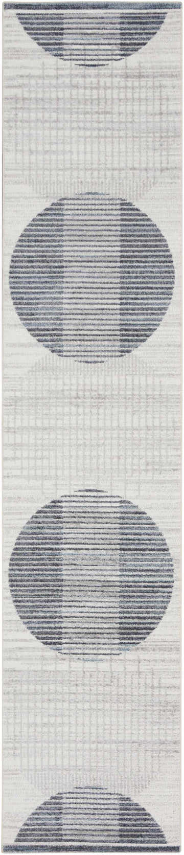 Close-up of the Nourison Astra Ivory Blue rug, featuring a mid-century modern circle and line pattern. Washable area rug.