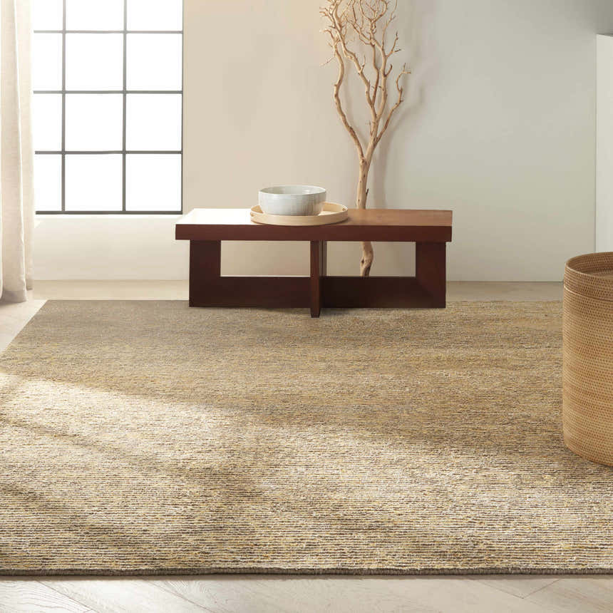 Minimalist room with a Calvin Klein Mesa Fossil rug, wood table, and woven basket.