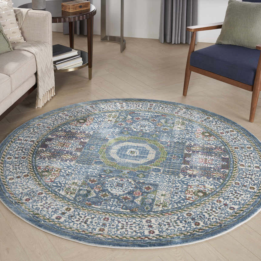 Living room with a round Nourison Ankara Global rug in ivory and light blue, bohemian style.