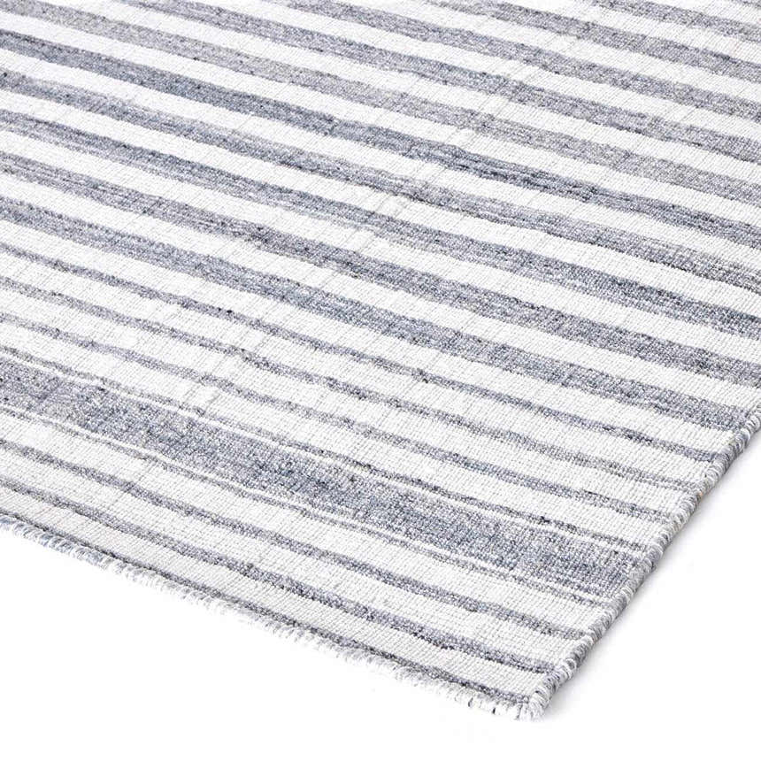 Close-up of the Four Hands Selena Outdoor Rug - Blue Stripe, showing the woven texture and striped pattern. Corner