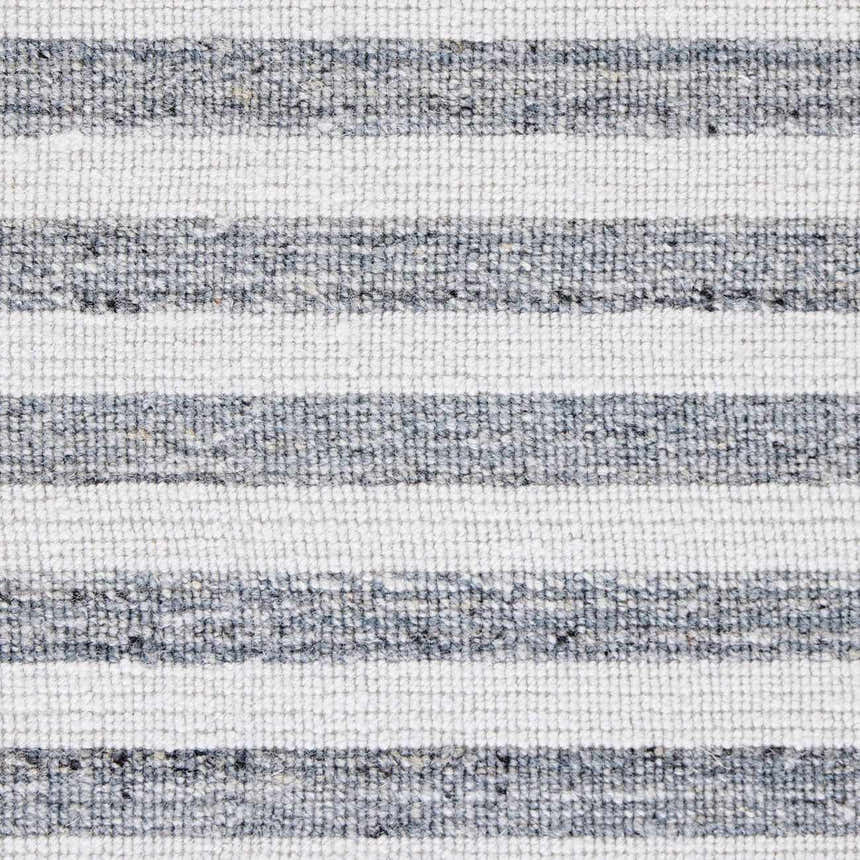 Close-up of the Four Hands Selena Outdoor Rug - Blue Stripe. Hand-woven PET rug with a textured blue and white striped pattern. Texture