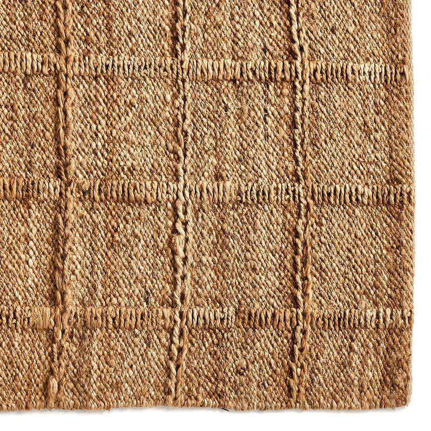 Close up of the Four Hands Grid Jute Rug, showcasing its natural jute fibers and hand woven grid pattern. Swatch