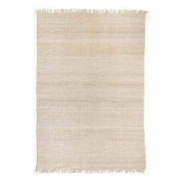 Close-up of Four Hands Neva Jute - Bleached Jute Area Rug. Beige jute rug with fringed edges. Rectangle shape. Design-Rectangle
