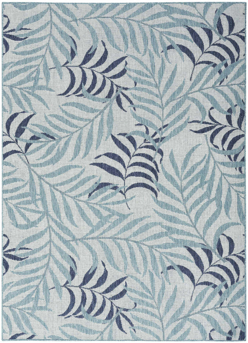 Close-up of Nourison Garden Oasis Blue Tropical Area Rug featuring a light and dark blue leaf pattern on a white background.