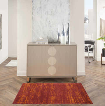 Hallway with wood floors and Nourison Essentials Red Modern Area Rug in front of a cabinet.