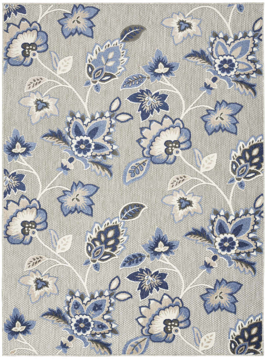 Close-up of Nourison Aloha Blue Grey Outdoor Area Rug with a floral pattern on a textured gray background.