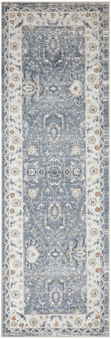 Close-up of the Nourison Astra Machine Blue Vintage Area Rug. Features a distressed, ornate pattern and light blue color.