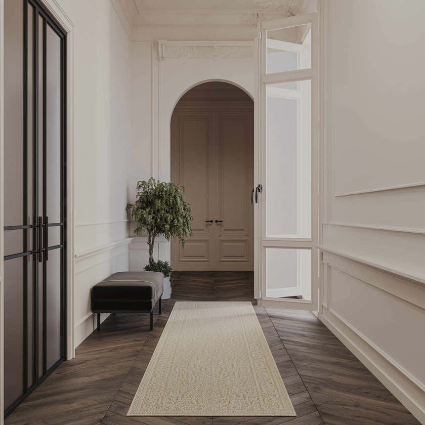 Elegant hallway with a Nourison Tulum Cream Outdoor Area Rug runner on dark wood floors.