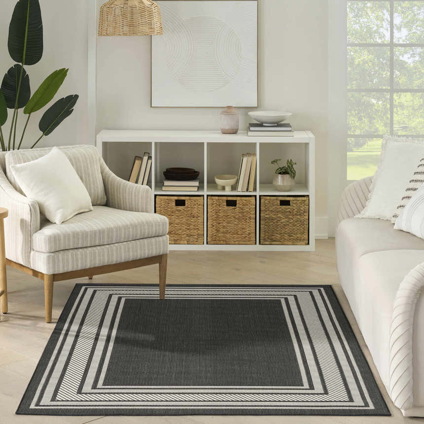 Living room with neutral furniture and Nourison Horizon Black Modern Area Rug.