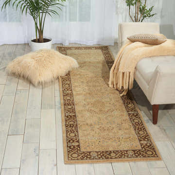 Living room scene with Nourison Persian Empire Sand Persian rug, neutral furniture, and plants.