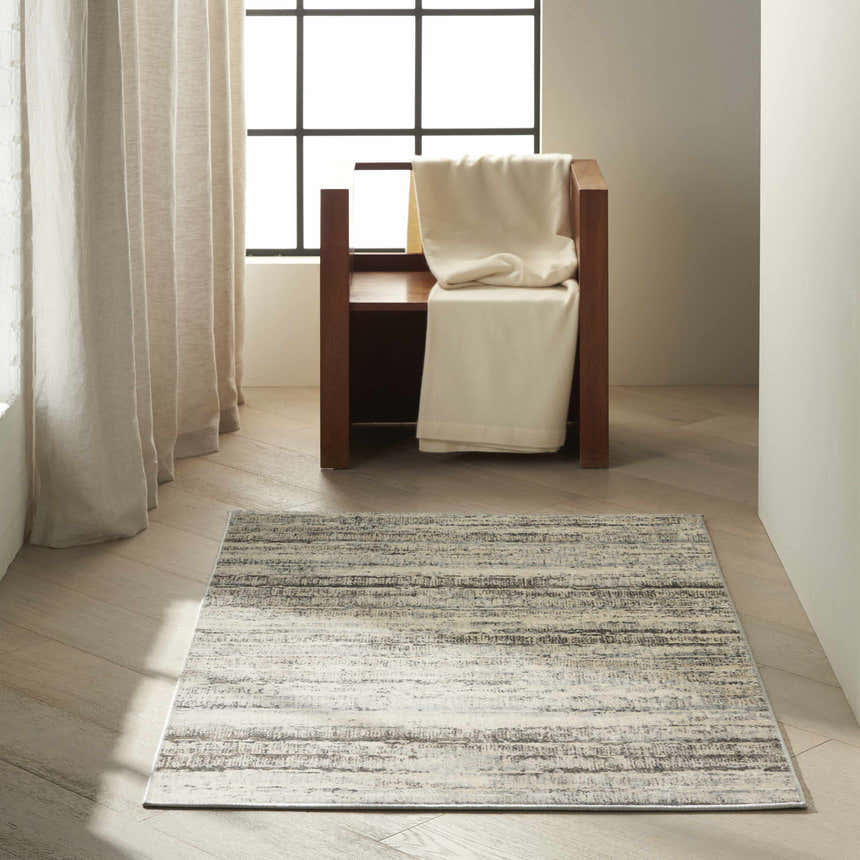 Minimalist room scene with a Calvin Klein Etched Ivory Beige rug, wood chair, and linen curtains.