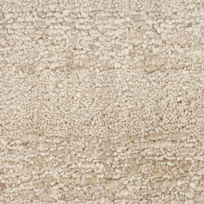 Close-up of the beige Calvin Klein CK043 Spun rug. Handmade New Zealand wool with a nubby, textured farmhouse design.