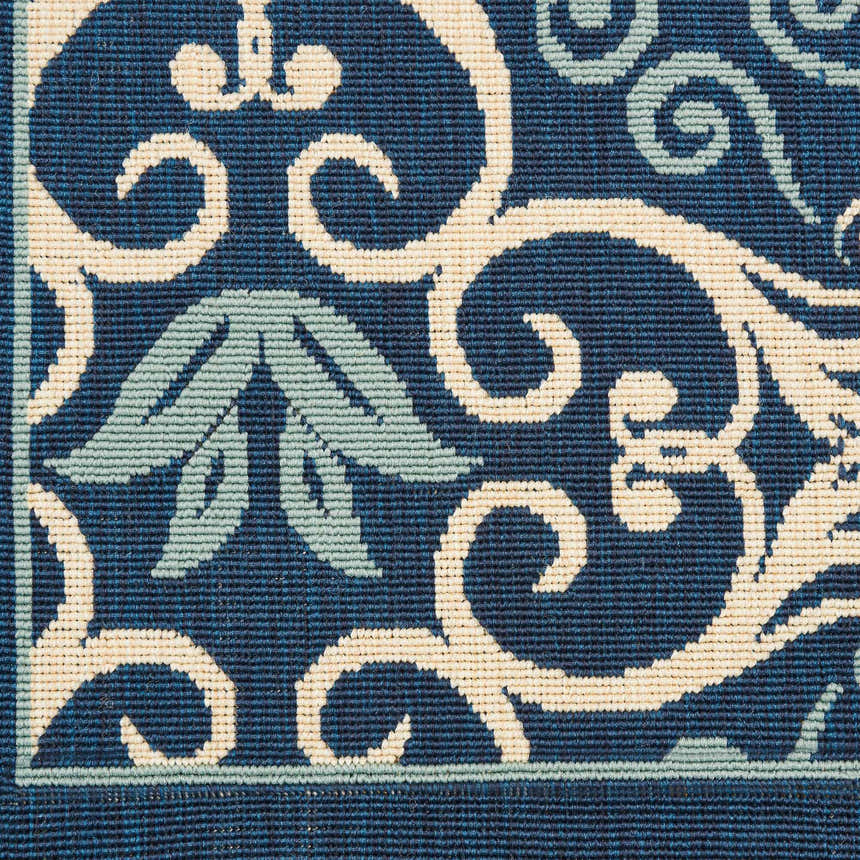 Close-up of Nourison Caribbean Navy Contemporary Area Rug pattern and texture. Navy, cream, and light blue floral design.