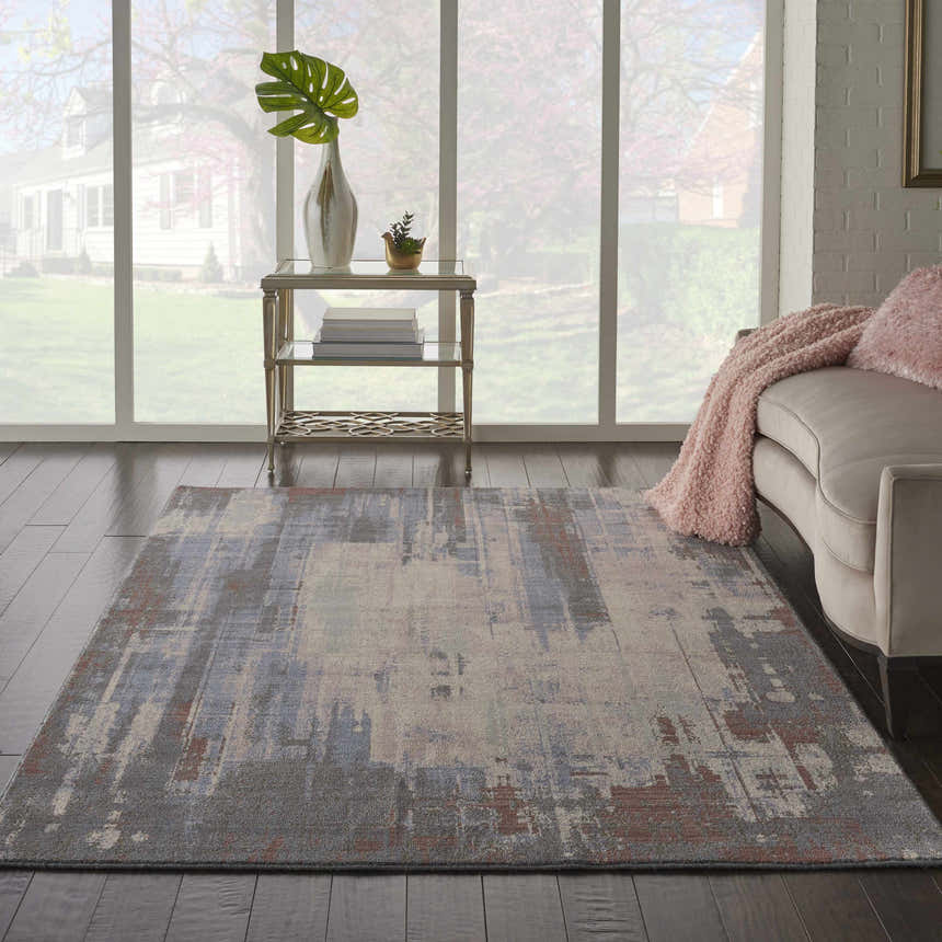 Living room scene with a Nourison Artworks Multicolor rug, sofa, side table, and large window view.