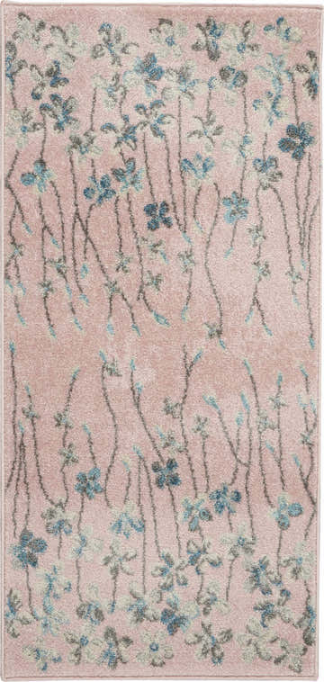 Close-up of the Nourison Tranquil Pink rug. Features a floral pattern with blue and gray flowers on a pink background.