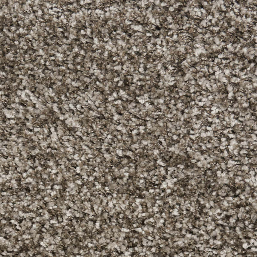 Close-up of the Nourison Amore Stone Shag rug, sandstone color. Soft, textured shag rug made of polypropylene and jute.