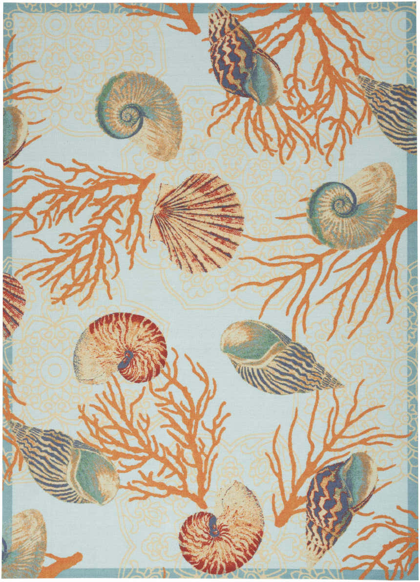 Close-up of Waverly Sun N' Shade Light Blue rug with coral and seashell pattern. Coastal style.