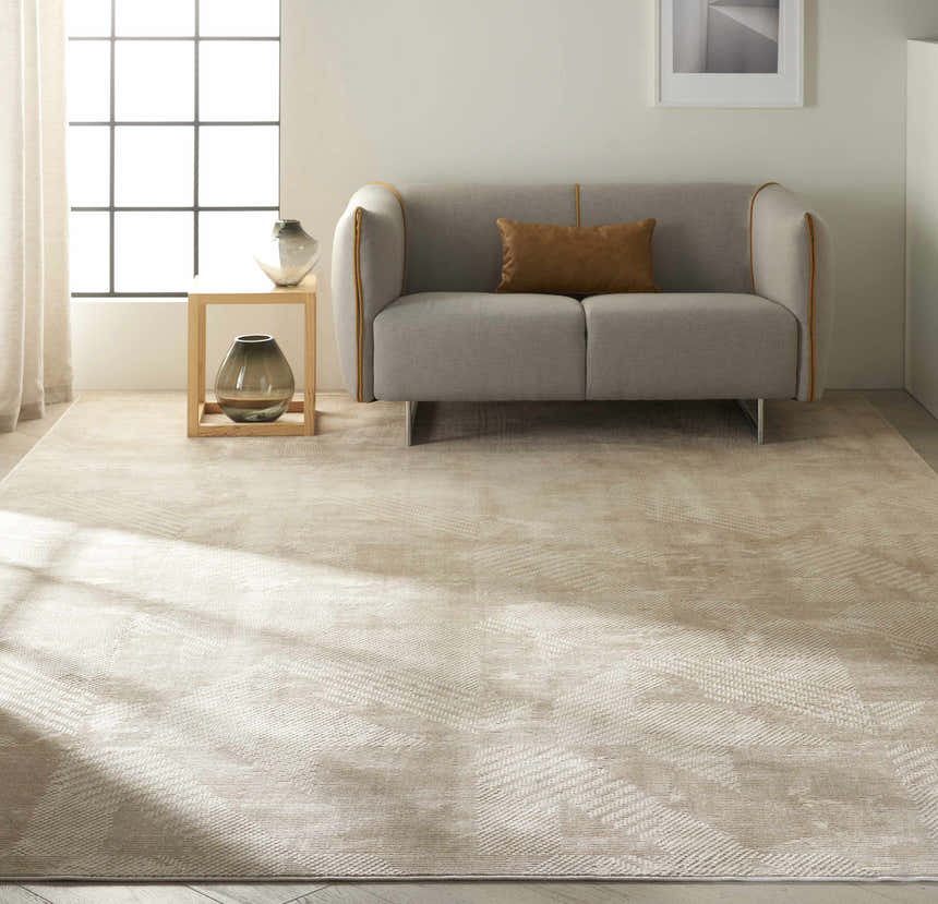 Modern living room with grey sofa and Calvin Klein Orlando Grey Saffron rug in neutral tones.