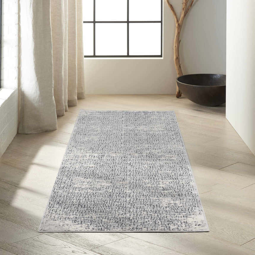 Hallway with Calvin Klein CK970 Vapor Ivory Black rug. Modern runner rug on light wood floors, neutral decor.