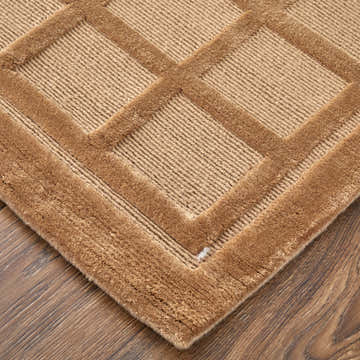 Close up of the tan Feizy Channels geometric area rug showing wool texture and pattern. Corner