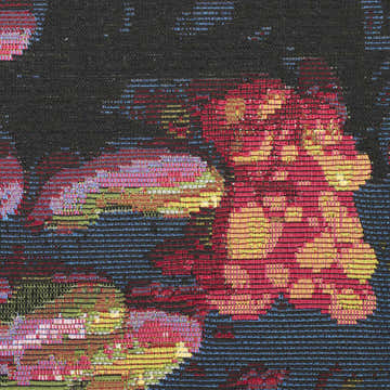Close-up of the Nourison Color Splash rug. Multicolor floral design with red, yellow, pink, green, and blue on a black background.