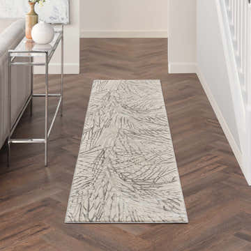 Hallway with Nourison Rustic Textures Ivory/Grey rug, wood floors, console table, and neutral decor. Modern style.