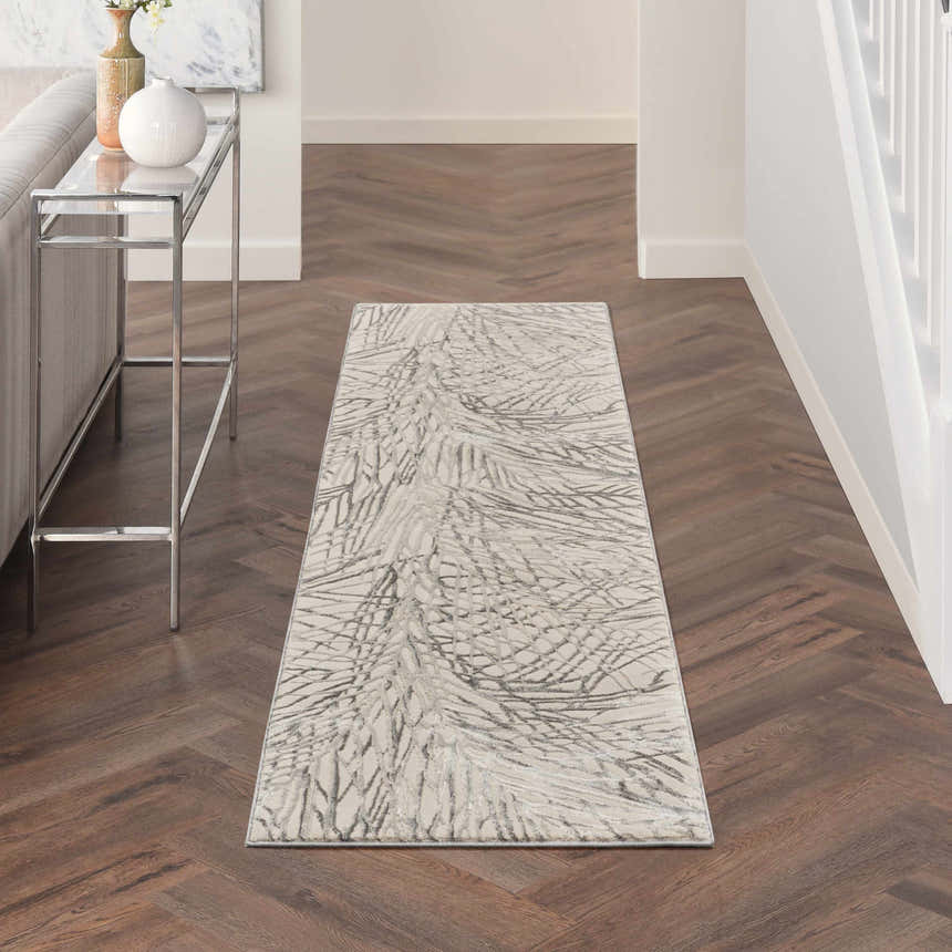 Hallway with Nourison Rustic Textures Ivory/Grey rug, wood floors, console table, and neutral decor. Modern style.